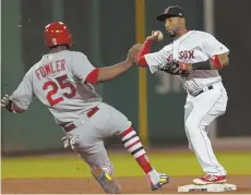  ?? STAFF PHOTOS BY JOHN WILCOX ?? QUITE A TURN OF EVENTS: After stepping on third base for the first out of the fourth inning last night, Rafael Devers (left) fires to second base to Eduardo Nunez (above) for the force on the Cardinals’ Dexter Fowler; Nunez then relayed to first to...