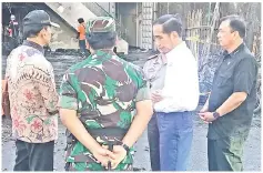  ??  ?? Joko (second right) with officials at the scene of an attack outside the Central Pantekosta church in Surabaya. — AFP photo