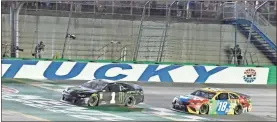  ?? Ap-timothy D. Easley ?? Kurt Busch crosses the finish line ahead of Kyle Busch to win the NASCAR Cup Series at Kentucky Speedway in Sparta, Ky., on Saturday.