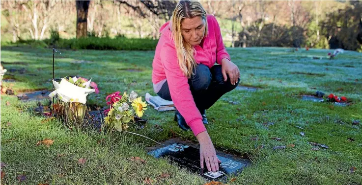  ??  ?? Leanne Perrin at the Marsden Valley Cemetary grave of her son Jayden who died 19 years ago.