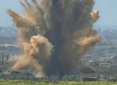  ?? OHAD ZWIGENBERG/AP ?? Smoke and debris rise Wednesday as the result of an explosion in the Gaza Strip as seen from southern Israel.