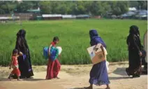  ?? - AFP ?? DISTURBED: Rohingya refugees walk with belongings in Jamtoli refugee camp near Ukhia in Bangladesh on November 12, 2018.