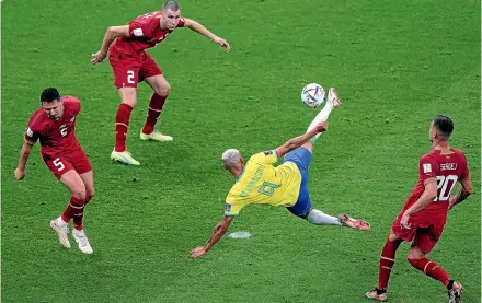  ?? ?? Richarliso­n scored both goals, the second from this stunning, acrobatic volley, in Brazil’s 2-0 win over Serbia at the World Cup yesterday.