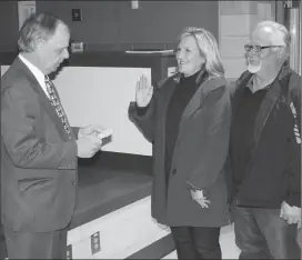  ?? Photo by Joseph B. Nadeau ?? North Smithfield Town Councilwom­an Terri Bartomioli, center, is sworn in by Town Administra­tor Gary Ezovski, left, as her husband, Michael, looks on.