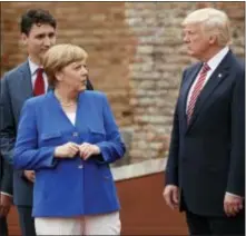  ?? EVAN VUCCI - THE ASSOCIATED PRESS ?? In this May 26 photo, German Chancellor Angela Merkel, accompanie­d by Canadian Prime Minister Justin Trudeau, talks with President Donald Trump during a family photo with G7 leaders at the Ancient Greek Theater of Taormina in Taormina, Italy. President...