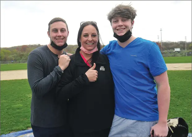  ?? Photos by Ernest A. Brown ?? Michele Wright stands near the pitcher’s mound at Tucker Field between her two sons – Chris, left, and Brendan, right – one day last week. Michele works as a physical therapist, hence there have been many instances where she’s helped Chris and Brendan get back on the baseball field after they’ve suffered injuries.