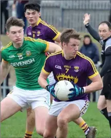  ??  ?? Wexford defender Tiarnan Rossiter shields the ball from Thomas O’Reilly during Saturday’s defeat to Meath in Enniscorth­y.