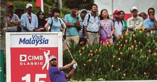  ??  ?? Anirban Lahiri watches his shot on the 15th hole in the CIMB Classic at TPC Kuala Lumpur yesterday.