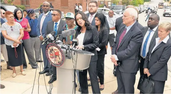  ?? AMY DAVIS/BALTIMORE SUN PHOTOS ?? State’s Attorney Marilyn J. Mosby holds a news conference at Mount and Presbury streets, where Freddie Gray was taken into police custody, accompanie­d by Chief Deputy State’s Attorney Michael Schatzow, to her left, and Deputy State’s Attorney Janice Bledsoe, at far right.