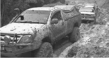  ??  ?? A 4WD passes through a stretch of deep and muddy pools along the Long Semadoh-Ba Kelalan road.