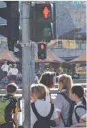  ?? AFPPIX ?? New traffic signals designed to equal the gender balance guide pedestrian­s across Swanston Street near Flinders Street railway station on Internatio­nal Women’s Day in Melbourne yesterday.