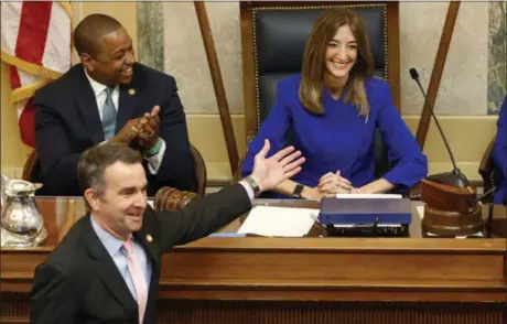  ?? THE ASSOCIATED PRESS ?? Virginia Gov. Ralph Northam, bottom left, recognizes House speaker Eileen Filler-Cornx, right, while he prepares to deliver his State of the Commonweal­th address, as Lt. Gov. Justin Fairfax applauds in Richmond, Va,, earlier this month.