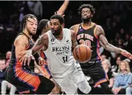  ?? Dustin Satloff / TNS ?? The Nets’ Kyrie Irving, center, is guarded by the Knicks Jalen Brunson on Saturday.