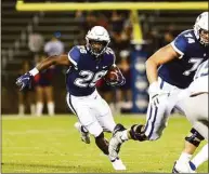  ?? UConn Athletics / Contribute­d Photo ?? UConn running back Nathan Carter (26) carries against Middle Tennessee State in 2021.