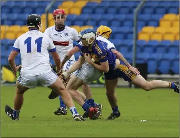  ??  ?? An hour after he had battled bravely for his beloved Annacurra, Carnew hurler Martin O’Brien returned to the field in Joule Park, Aughrim, to play a key role in the SHC quarter-final clash with Éire Óg. Here he has his path blocked by Eire Og’s Danny...