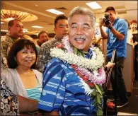  ?? AP/MARCO GARCIA ?? Hawaii Gov. David Ige mingles with supporters Saturday at his campaign headquarte­rs in Honolulu. Ige won the Democratic primary over U.S. Rep. Colleen Hanabusa and will seek a second term in office.