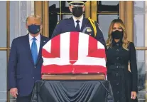  ?? J. SCOTT APPLEWHITE/ASSOCIATED PRESS ?? President Donald Trump and first lady Melania Trump pay respects Thursday as Justice Ruth Bader Ginsburg lies in repose at the Supreme Court building in Washington. Ginsburg, 87, died of cancer on Sept. 18.