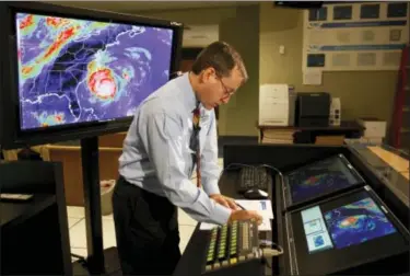  ?? LYNNE SLADKY — THE ASSOCIATED PRESS FILE ?? Chief hurricane forecaster James Franklin prepares for a live update on Hurricane Earl at the National Hurricane Center in Miami. Franklin is a retiring chief of the hurricane specialist unit at the National Hurricane Center in Miami.