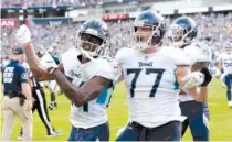  ?? AP PHOTO/MARK ZALESKI ?? Tennessee Titans wide receiver Corey Davis, left, celebrates with offensive tackle Taylor Lewan after Davis caught the winning touchdown pass against the Philadelph­ia Eagles in overtime during Sunday’s game in Nashville. The Titans won 26-23.