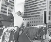  ?? Leah Hennel/calgary Herald ?? Calgary Mayor Naheed Nenshi was cheered as he rode a horse named Garfield during the parade.