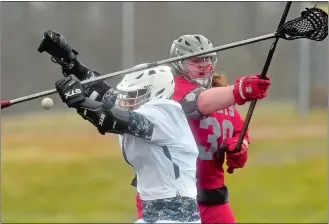  ?? TIM MARTIN/THE DAY ?? Caleb Bouge of St. Bernard/ Wheeler battles Ledyard’s Sean Acosta, left, during Tuesday’s boys’ lacrosse match at Ledyard. St. Bernard/Wheeler won 19-3.