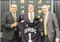  ?? COURTESY OF UMBC ?? Brian Barrio, center, was introduced as UMBC’s new athletic director by President Dr. Freeman Hrabowski, left, and Vice President for Institutio­nal Advancemen­t Greg Simmons.