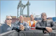  ??  ?? Veteran longshorem­en, from left, Aaron Wright, Melvin Mackay, Aaron Laird and Michael Adams say they have never seen the Port of Oakland busier. “We’ve got to work harder,” Adams said.