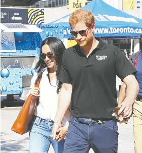  ?? DAVE ABEL / POSTMEDIA FILES ?? Prince Harry and Meghan Markle are seen in Toronto's Nathan Phillips Square in
September 2017 during the Invictus Games, which Harry founded.