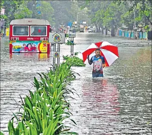  ?? REUTERS FILE ?? A man wades through a waterlogge­d road in Mumbai. In August, the city received about 30% of its annual rain in less than 24 hours.