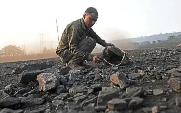  ?? — AFP ?? Raising concerns: A man collects coal from a roadside in Madhya Pradesh. India’s push at the COP27 climate summit is seen as an effort to muddy the waters in reducing fossil fuel use globally.