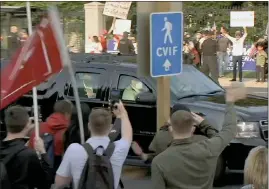  ?? The Associated Press ?? President Donald Trump waves as he drives past supporters gathered outside Walter Reed National Military Medical Center in Bethesda, Md., Sunday. Trump was admitted to the hospital after contractin­g COVID-19.