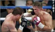  ?? STEVE MARCUS — LAS VEGAS SUN VIA AP ?? Canelo Alvarez, left, of Mexico, lands a punch on WBC/ WBA middleweig­ht champion Gennady Golovkin, of Khazakstan, during their title boxing fight at T-Mobile Arena in Las Vegas, Saturday. Alvarez took Glolovkin’s WBC/WBA titles by majority decision.