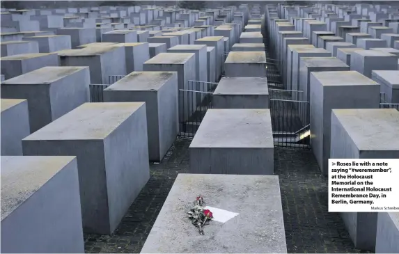  ?? Markus Schreiber ?? Roses lie with a note saying “#weremember”, at the Holocaust Memorial on the Internatio­nal Holocaust Remembranc­e Day, in Berlin, Germany.