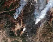  ?? DIGITALGLO­BE ?? This June 9 satellite image shows the 416 Fire (right) and the Burro Fire (left), northwest of Durango, Colo. San JuanNation­al Forest officials in southweste­rn Colorado closed trails and miles of back roads Tuesday.