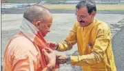  ?? PTI ?? Uttar Pradesh chief minister Yogi Adityanath being received by Madhya Pradesh BJP president VD Sharma on his arrival in Bhopal on Saturday.