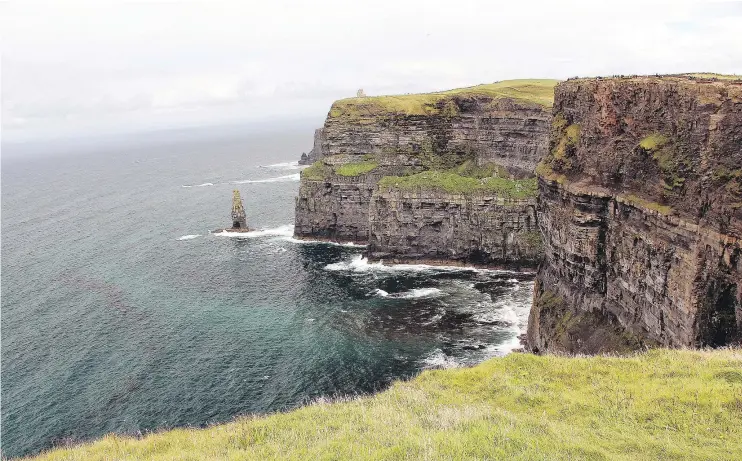  ?? — PHOTOS: KEN DONOHUE ?? The Cliffs of Moher in Ireland plunge into the Atlantic Ocean, marking the end of an island filled with wonder and enchantmen­t.