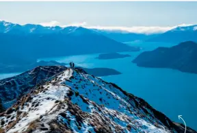  ??  ?? Savvy travel team Dalene and Pete Heck highfive atop New Zealand’s Roys Peak, enjoying wonderful views of Lake Wanaka.