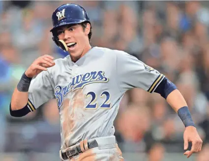  ?? JAKE ROTH / USA TODAY SPORTS ?? Brewers outfielder Christian Yelich reacts after scoring on a double by Lorenzo Cain during the fourth inning at Petco Park. Yelich went 5 for 5 with two RBI and scored three of the Brewers’ seven runs Saturday.