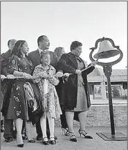  ?? AP/KATE BRUMBACK ?? Members of the King family on Wednesday ring a bell in front of the crypt of Martin Luther King Jr. and Coretta Scott King in Atlanta.