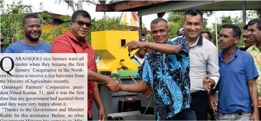  ?? Photo: SUPPLIED ?? Qaraniqoli Farmers’ Co-operative president Vinod Kumar receives the key for a new rice harvester from Minister for Agricultur­e, Waterways and Environmen­t, Dr Mahendra Reddy as other rice farmers look on.