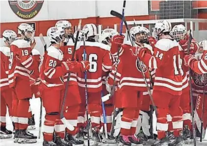  ?? COURTESY PHOTO ?? Members of the Spaulding High School boys hockey team celebrate after Saturday’s 4-3 upset over top-seeded Merrimack in a Division II quarterfin­al at West Side Arena in Manchester. The eighth-seeded Red Raiders will face No. 5 Dover on Wednesday in a semifinal at Everett Arena in Concord.
