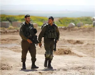  ?? (Amir Cohen/Reuters) ?? IDF SOLDIERS patrol on Israel’s side of the border with the northern Gaza Strip last week.