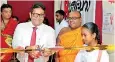  ??  ?? Seylan Bank Director and CEO Kapila Ariyaratne opening the 200th ‘Seylan Pahasara’ library