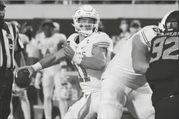  ?? ASSOCIATED PRESS ?? TEXAS QUARTERBAC­K SAM EHLINGER (11) throws a touchdown pass in overtime of a game against Oklahoma State in Stillwater, Okla., on Saturday.