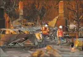  ?? Genaro Molina Los Angeles Times ?? PACIFIC GAS and Electric Co. workers make their way through fire-ravaged Santa Rosa in 2017. PG&amp;E equipment was linked to multiple wildfires that year.