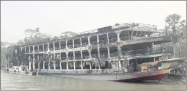  ?? THE ASSOCIATED PRESS ?? A burnt passenger ferry is seen anchored off the coast of Jhalokati district on the Sugandha River in Bangladesh on Friday.