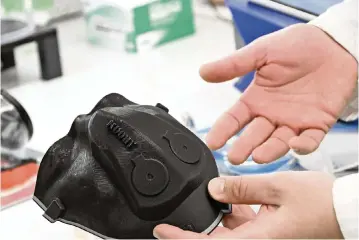  ?? Kim Hairston/The Baltimore Sun/TNS ?? Kevin Aroom, research engineer at the University of Maryland Robert E. Fischell Institute for Biomedical Devices, holds a 3D-printed custom conformal mold for a respirator based on a scan of his face to fashion a custom-fitted mask, on March 3, 2022.