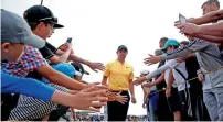  ?? Reuters ?? Rory McIlroy walks off the 10th green past spectators during the final round on Sunday. —