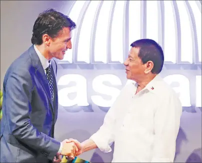  ?? CP PHOTO ?? Canadian Prime Minister Justin Trudeau talks to Philippine President Rodrigo Duterte before the opening ceremony of the 31st Associatio­n of Southeast Asian Nations Summit in Manila, Philippine­s Monday.
