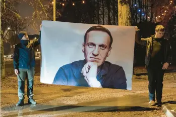  ?? ANDREJ VASILENKO/THE NEW YORK TIMES ?? Supporters of Russian opposition leader Alexei Navalny display his image Feb. 23 in Boris Nemtsov Square near the Russian Embassy in Vilnius, Lithuania. The square honors Nemtsov, a murdered Putin critic.